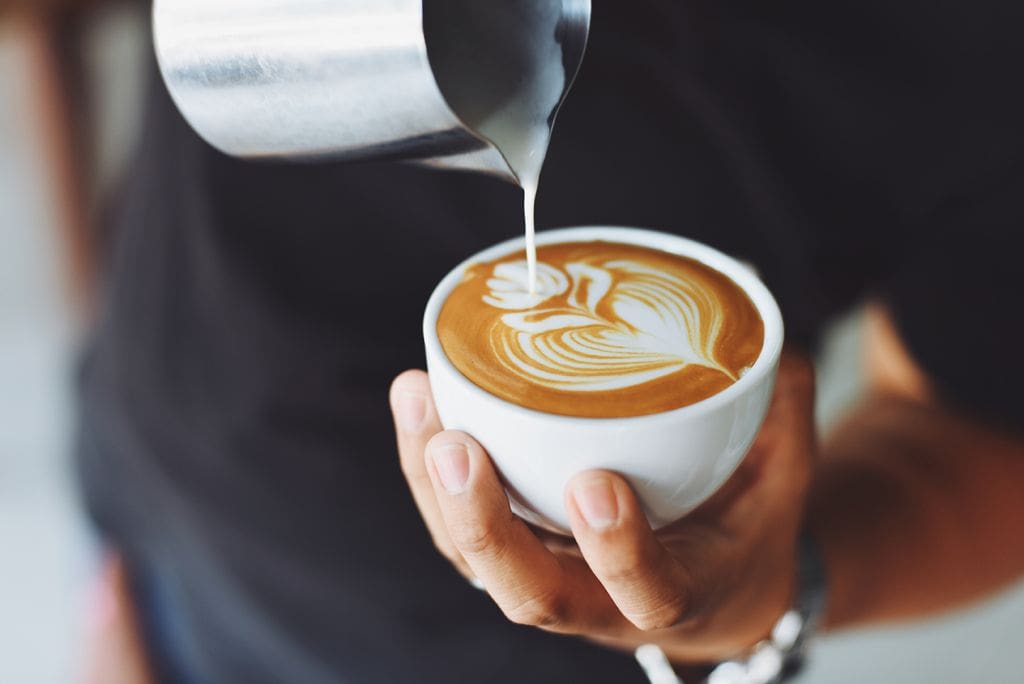 barista making latte