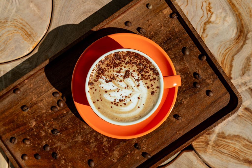 cup of perfectly made coffee in orange mug