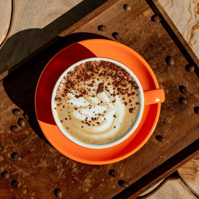 cup of perfectly made coffee in orange mug