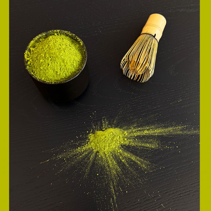 matcha tea on dark wooden table with green color pop
