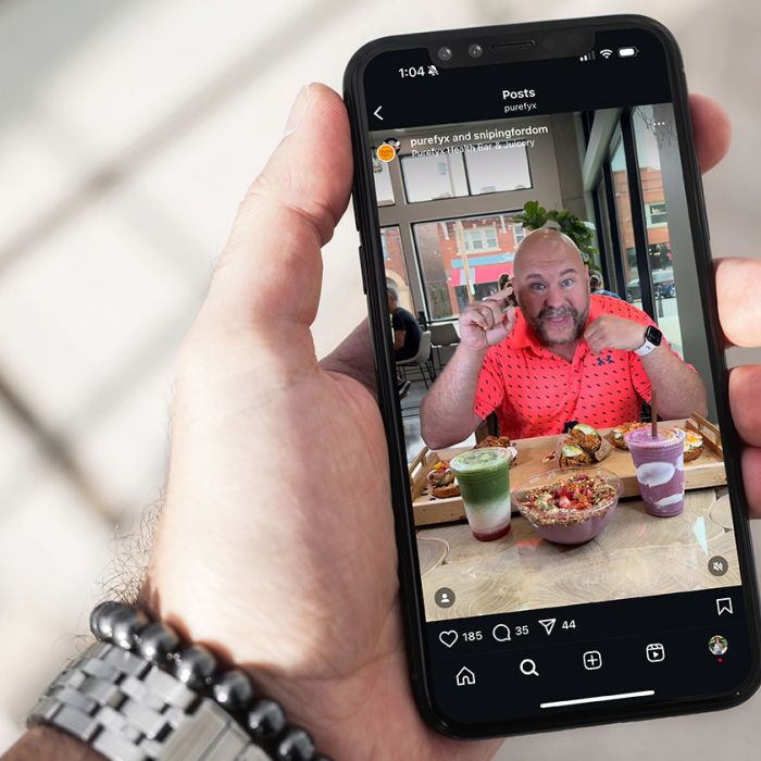 man holding a cell phone with PureFyx Instagram post featuring Snipping for Dom